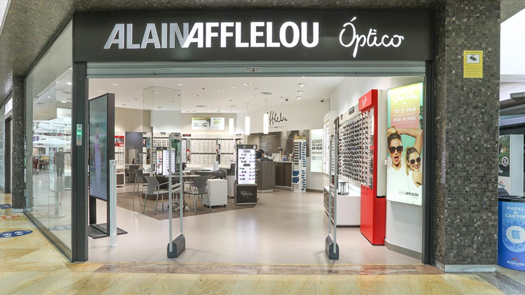 The entrance of Alain Afflelou features a modern optical store with displays of glasses and a welcoming interior.