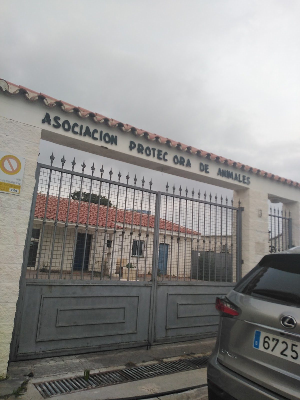 The entrance gate of Animal Home features a sign reading "Asociación Protectora de Animales" in Torremolinos.