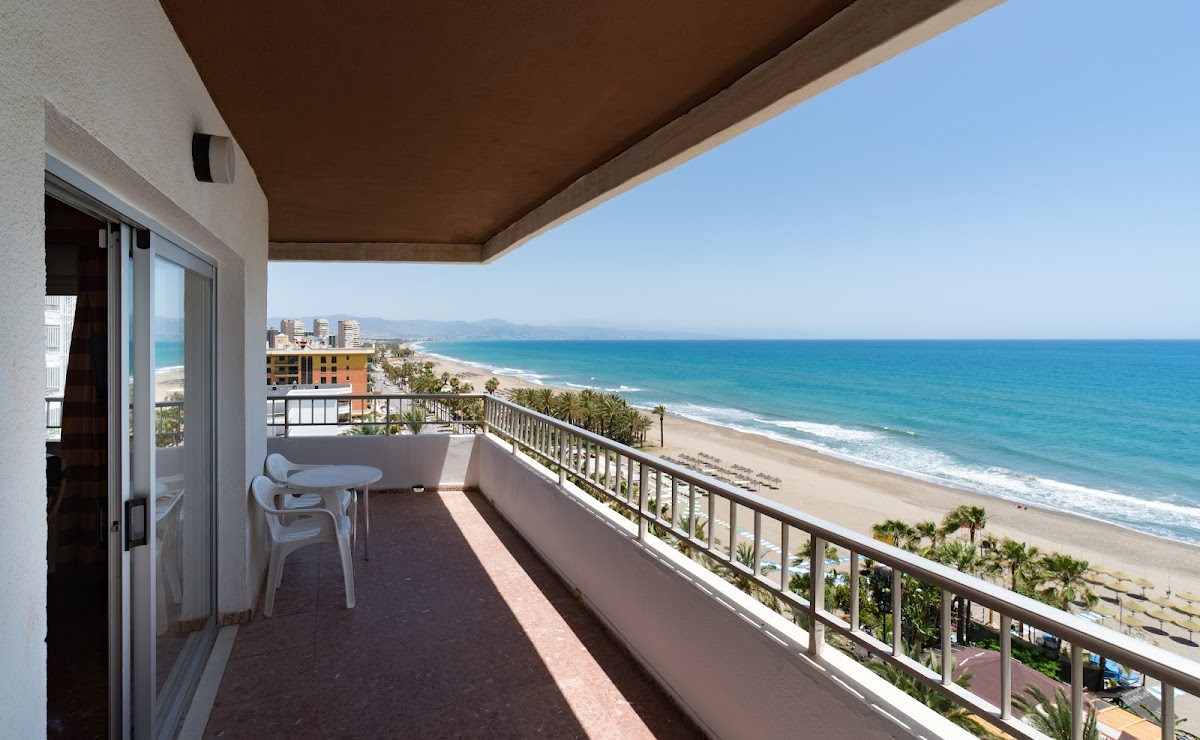 View from a balcony at Apartamentos Bajondillo, overlooking the beach and sea in Torremolinos.