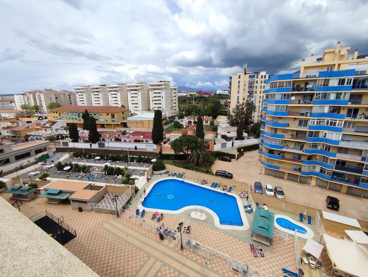 Aerial view of Apartamentos Turísticos Nuriasol featuring a large pool and surrounding residential area.