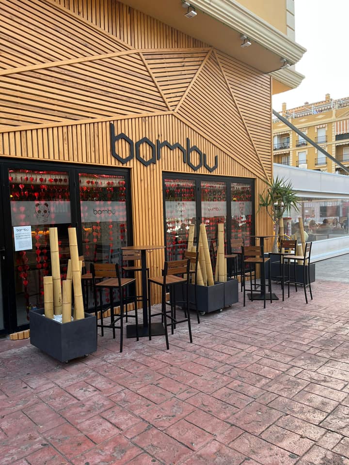 Exterior view of Bambú - Café y copas featuring bamboo decor and outdoor seating.