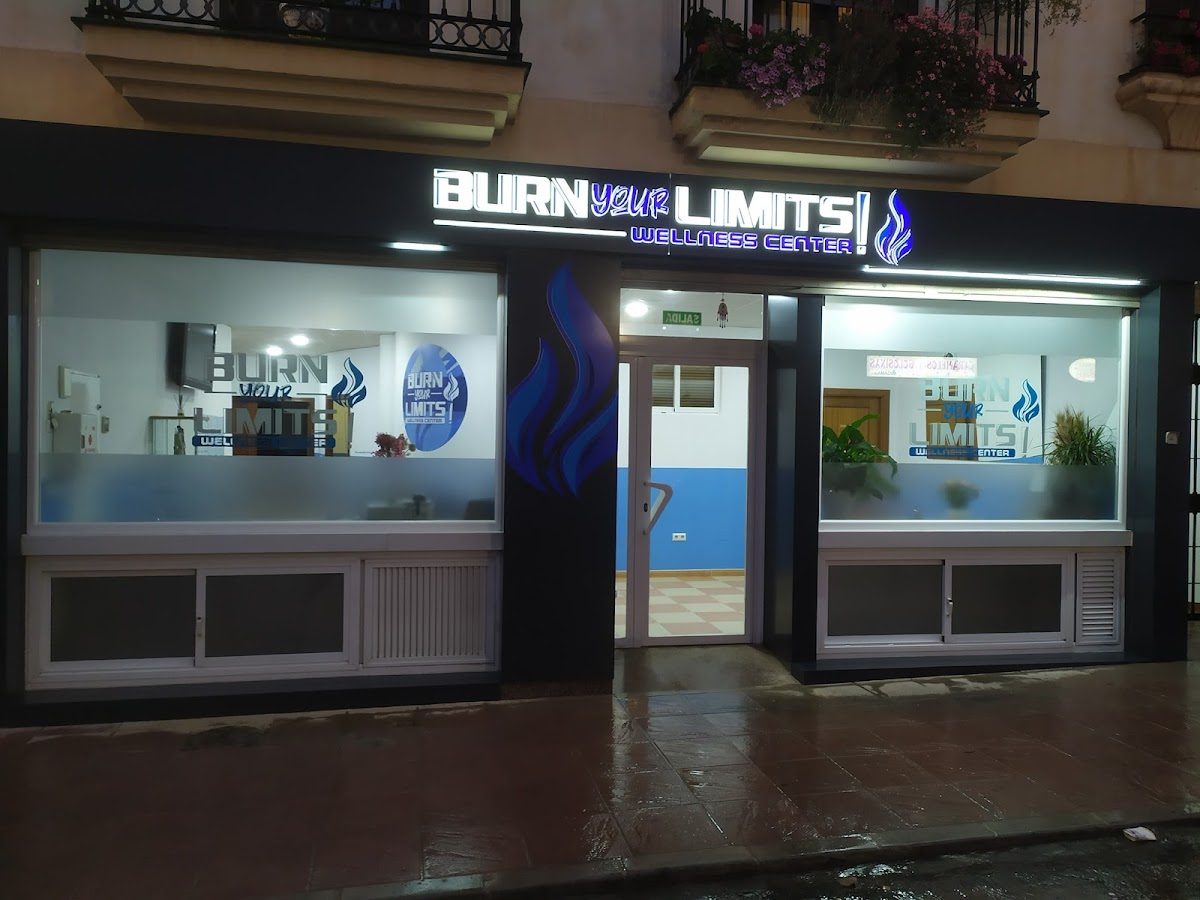 The exterior of Burn Your Limits Wellness Center features a modern design with blue accents and large windows.