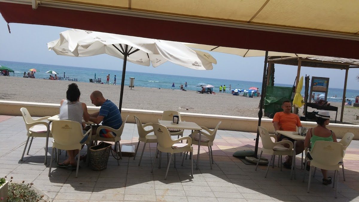 Café Bar Don Pedro features outdoor seating with beach views and umbrellas on Av. de España, El Morche.