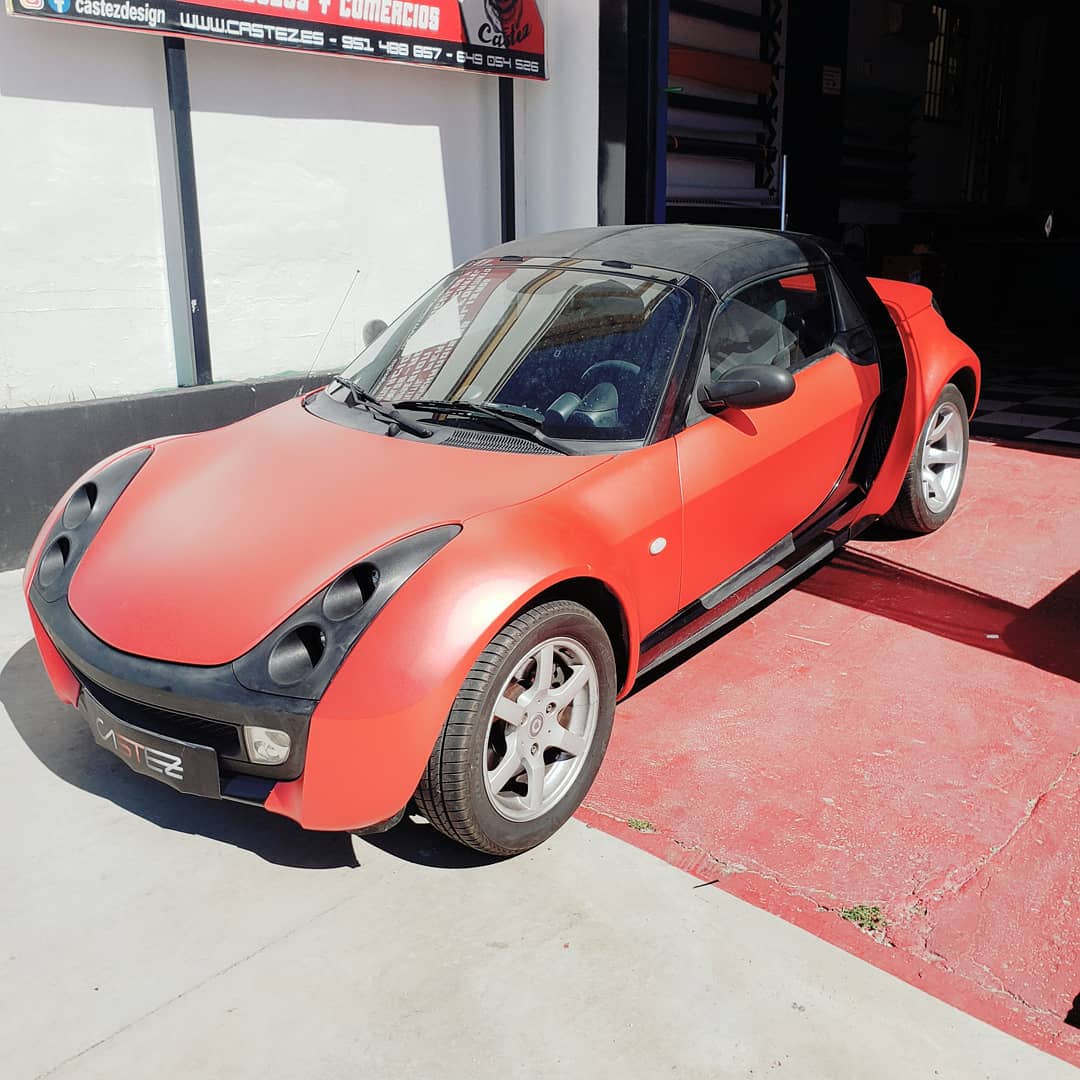 A red sports car parked outside Castez Design in Rincón de la Victoria, Málaga.
