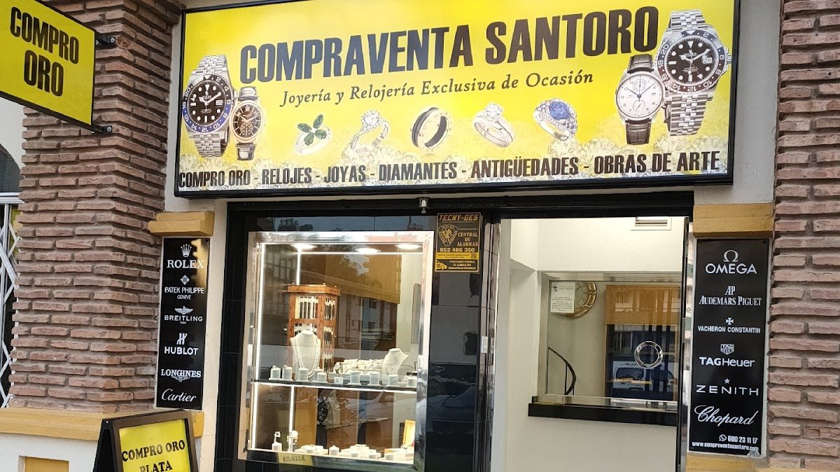 The storefront of Compraventa Santoro features a variety of jewelry, watches, and art pieces on display.