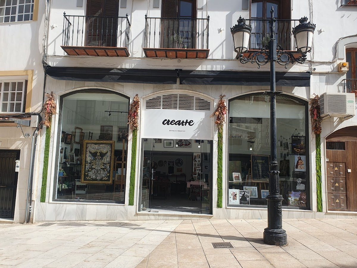 The exterior of Crearte, a creative space, featuring large windows and decorative elements on the facade.