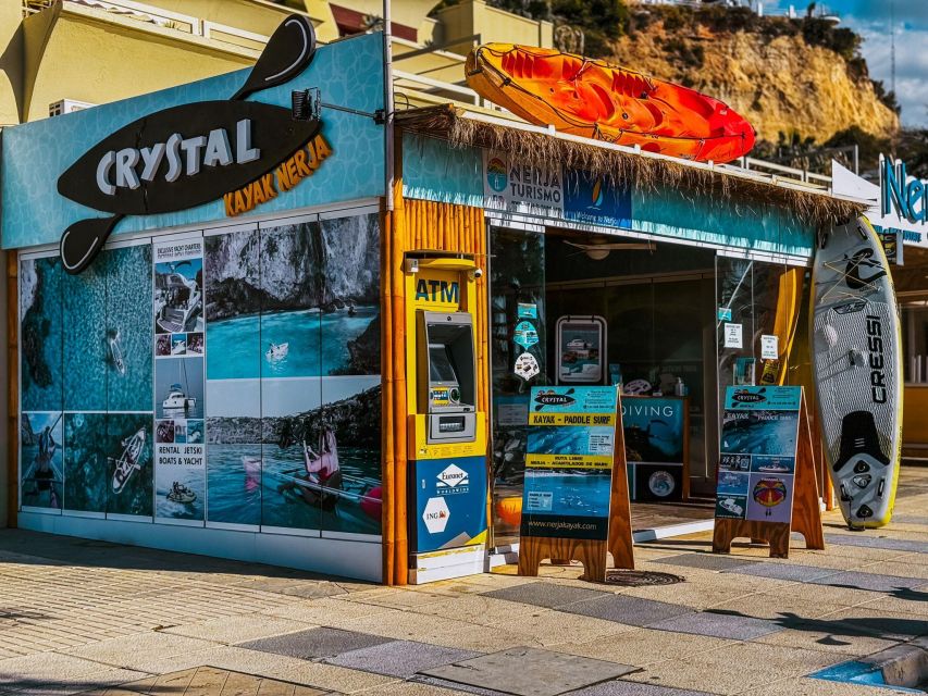 Crystal Kayak Nerja storefront featuring kayaks, signage, and promotional materials on display.