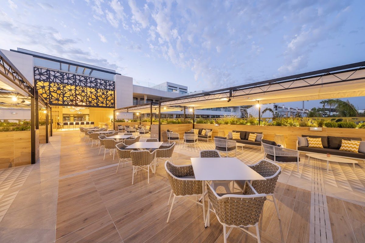 The Eurostars Oasis Marbella features an outdoor terrace with stylish seating and lush greenery.
