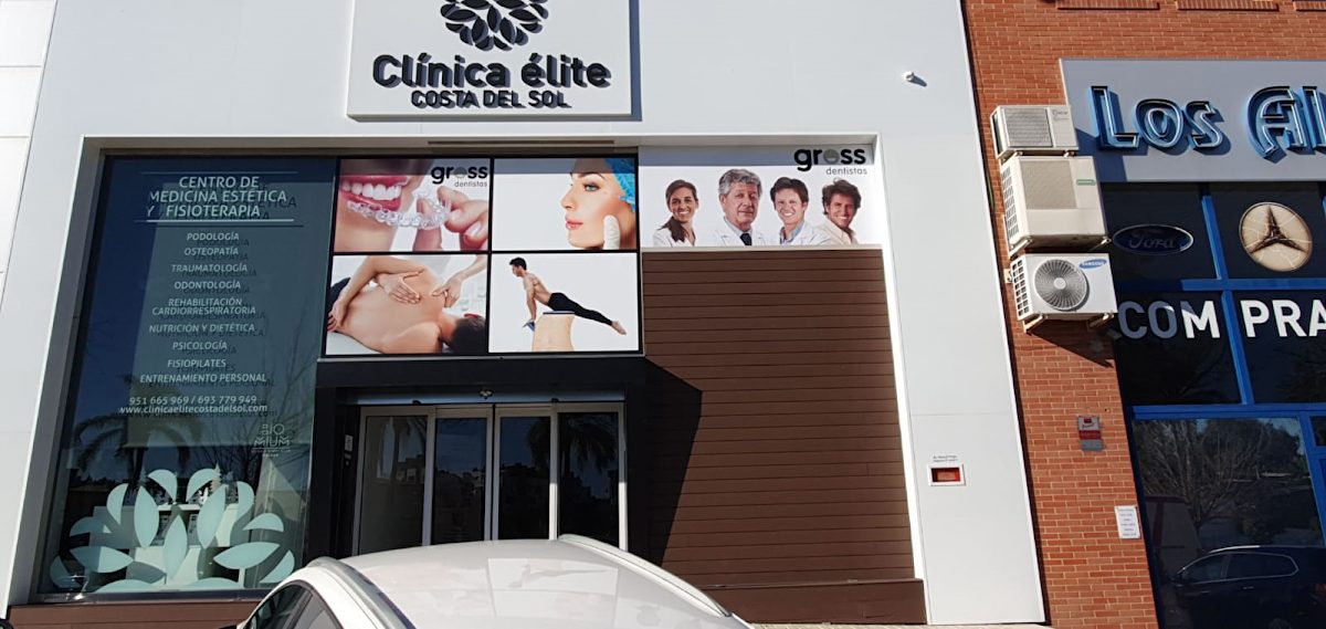 Exterior of Gross Dentistas with signage and images promoting dental and aesthetic services.