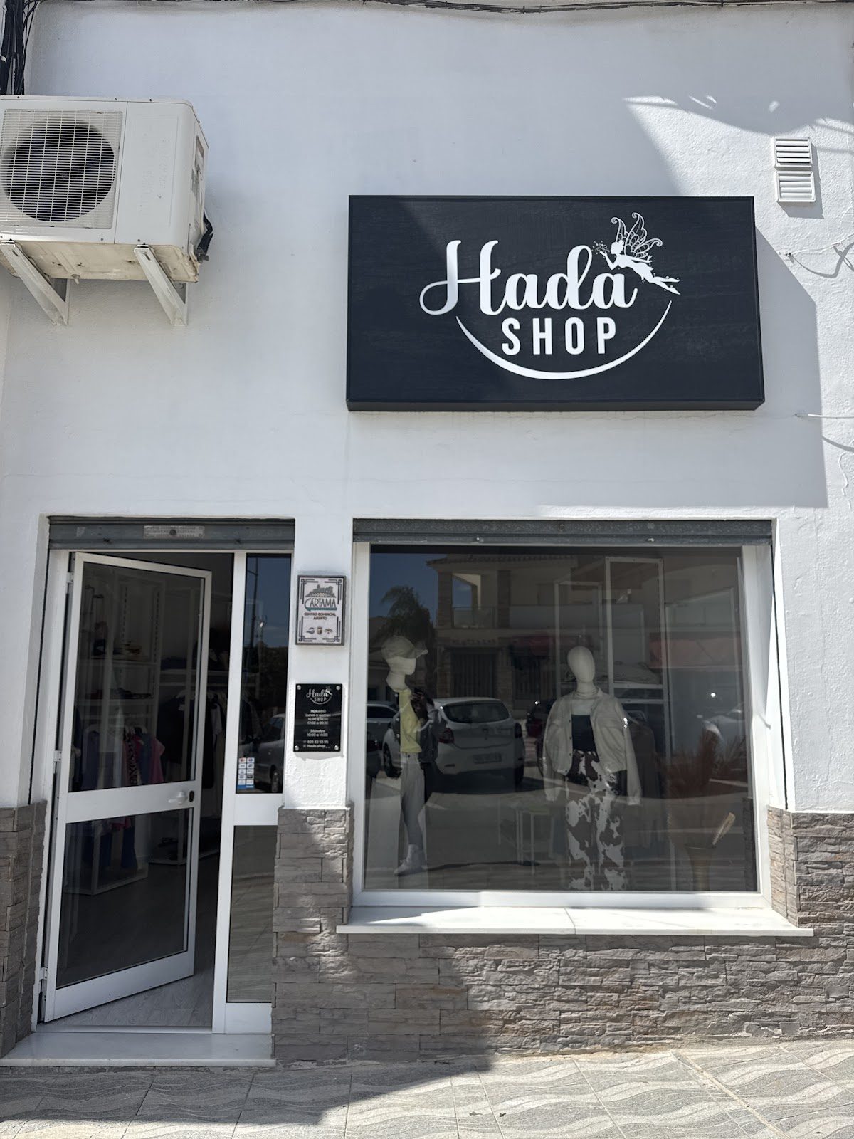 Hada Shop features a modern storefront with a large window displaying mannequins and clothing.