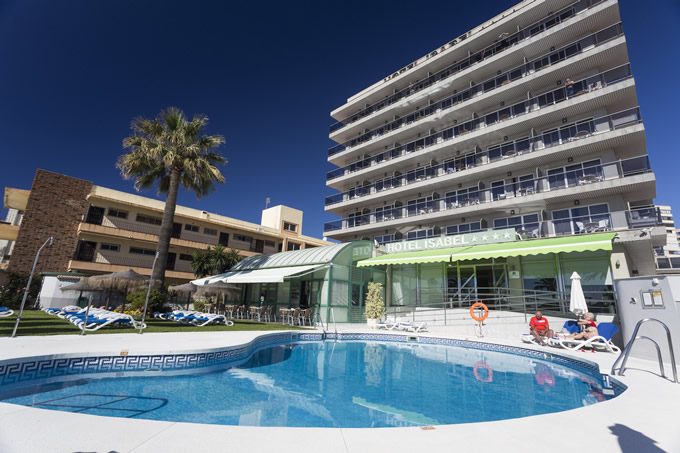Hotel Isabel features a swimming pool surrounded by sun loungers and a modern building in Playamar, Torremolinos.