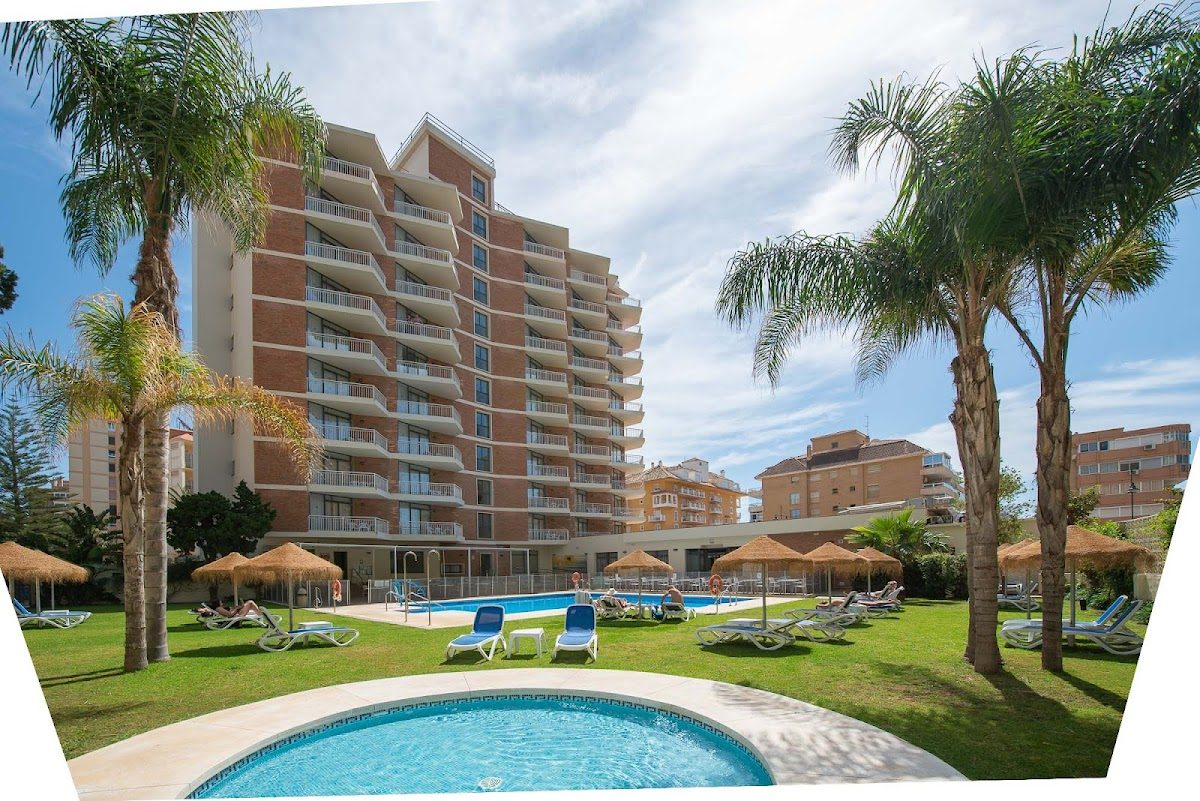 Hotel Mainare Playa features a pool area surrounded by palm trees and sun loungers.