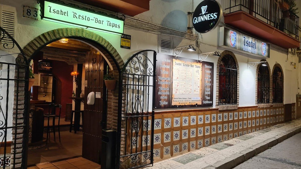 The exterior of ISABEL Resto, Bar, Tapas features a welcoming entrance with decorative tiles and illuminated signage.