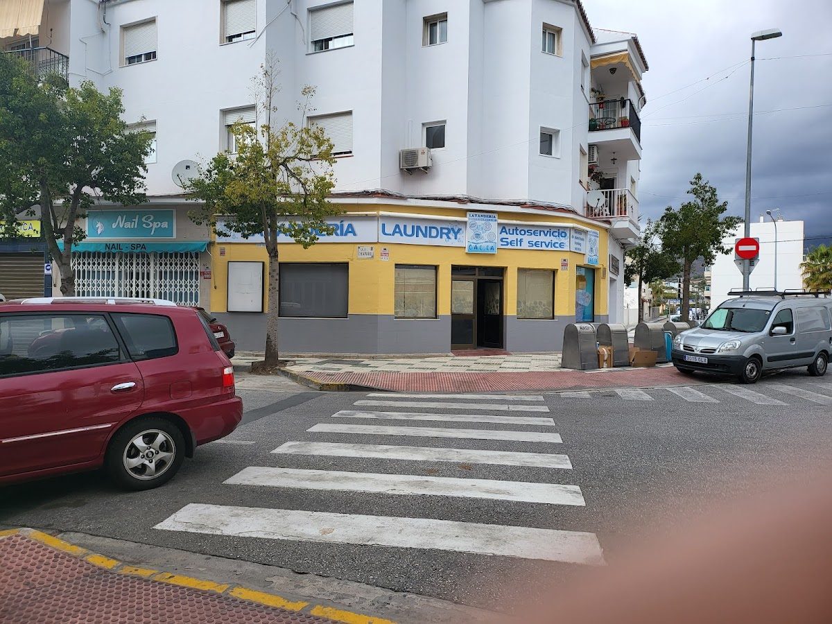 Lavandería Gal.la features a self-service laundry exterior with a yellow and blue facade on a street corner.