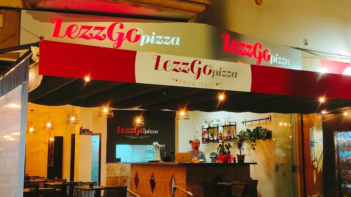 LezzGoPizza features a colorful awning and a cozy outdoor seating area in Torremolinos.