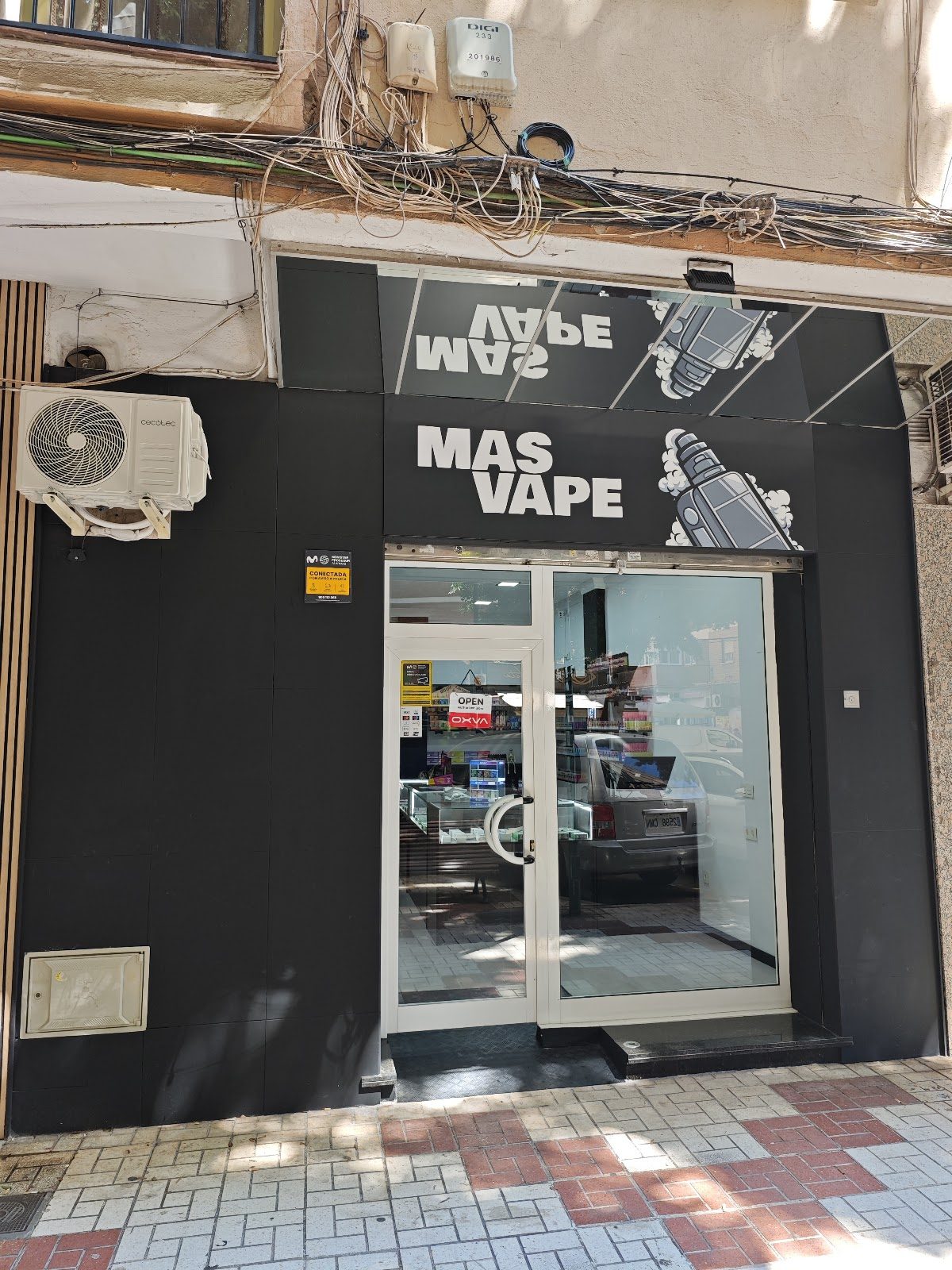 Exterior view of MASVAPE store in Málaga, featuring a modern entrance and signage.