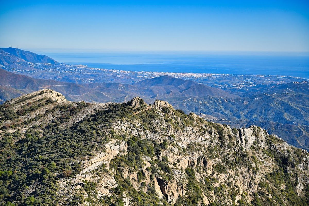 Stunning panoramic view from Mirador de Juanar overlooking mountains and the coastline of Málaga.