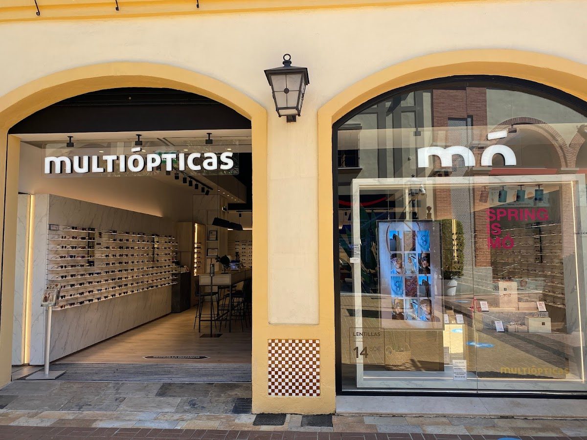 Multiópticas features a modern storefront with a display of eyeglasses and a welcoming entrance in Churriana, Málaga.