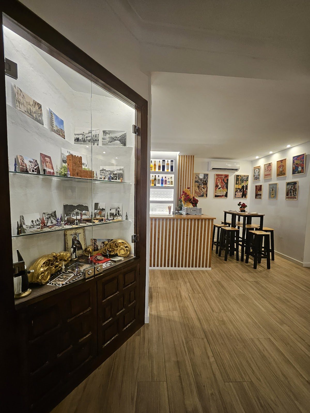Interior view of Pub El Palquito featuring a display case and bar area with seating.