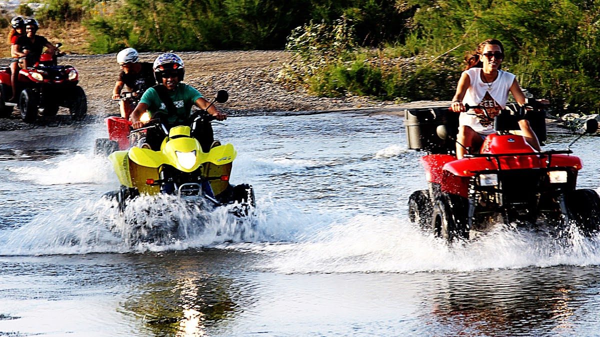 ATVs splashing through water during an outdoor adventure at Quad Aventura Costa Del Sol in Churriana.