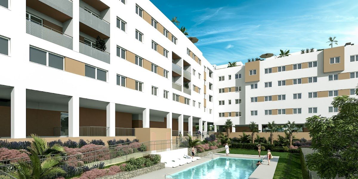 Residencial Los Olivos features modern apartments surrounding a pool area with landscaped gardens in Vélez-Málaga.