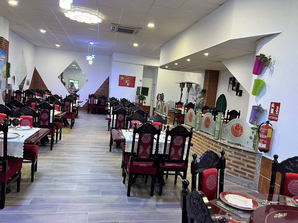 Interior del Restaurante Chino Olímpica II en Mollina, con asientos y elementos decorativos en rojo y negro.