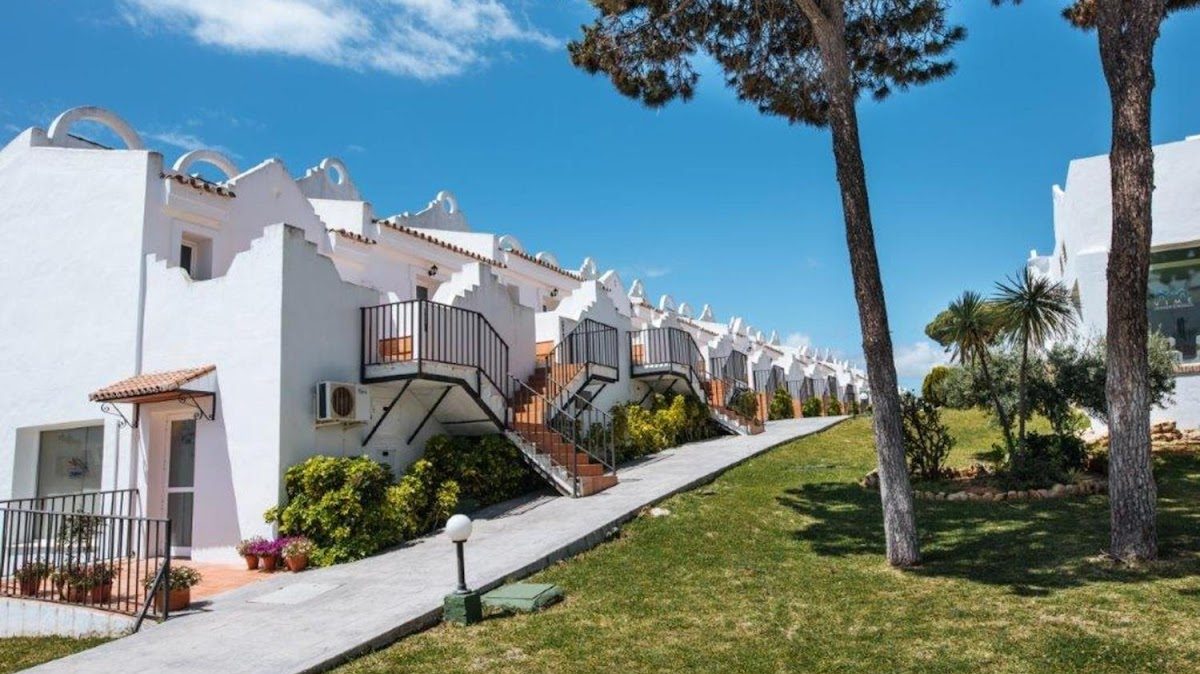 White buildings with balconies set in a landscaped area at Sercotel Vime La Reserva de Marbella.