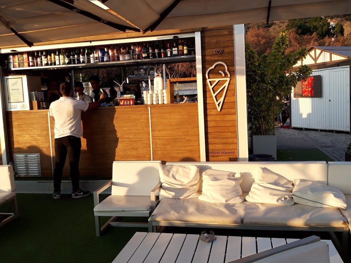 The Small-Café features a bar with a variety of drinks and outdoor seating.