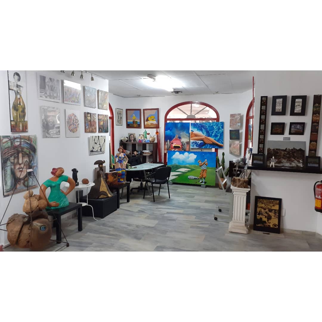 Interior of Studio 33 featuring colorful artwork, sculptures, and a welcoming atmosphere for art enthusiasts.