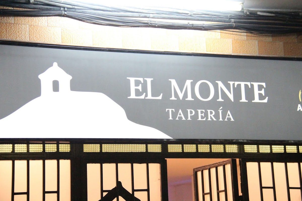 Signage for Tapería El Monte featuring the restaurant name and a silhouette of a building.