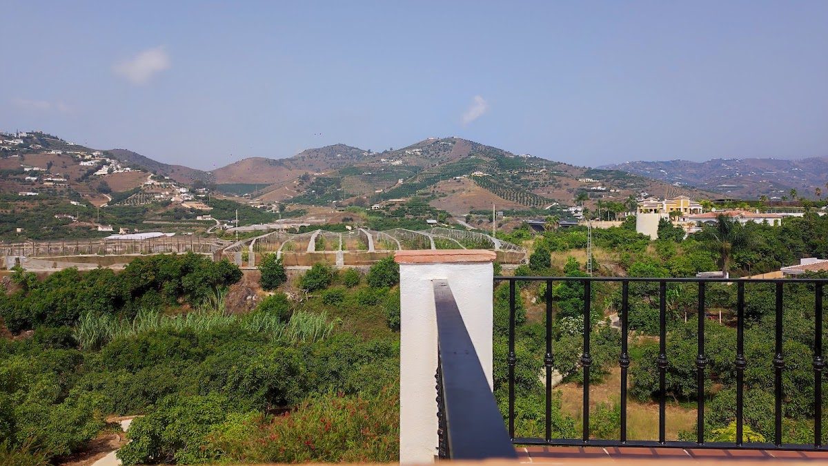 Scenic view from Villa Monica overlooking hills and vineyards in Nerja, Málaga.
